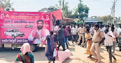 Oustees tear the banners of the BRS at R&R Colony in Gajwel on Saturday.