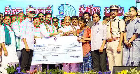 Chief Minister A Revanth Reddy presents cheque of Rs 1 crore to the family of Excise Constable Sowmya.