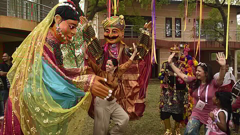 A group of youngsters dance and have fun in the music along with giant puppets during the puppet workshop as part of Avakai Film Festival at Bhavani Island in Vijayawada on Saturday.