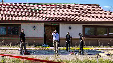 Fremont County coroner Randy Keller, center, and other authorities survey the area where they plan to put up tents at the Return to Nature Funeral Home where over 100 bodies have been improperly stored, Oct. 7, 2023, in Penrose, Colo.
