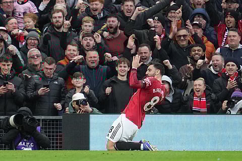 Manchester United's Bruno Fernandes celebrates after scoring during the English Premier League soccer match between Manchester United and Tottenham in Manchester.