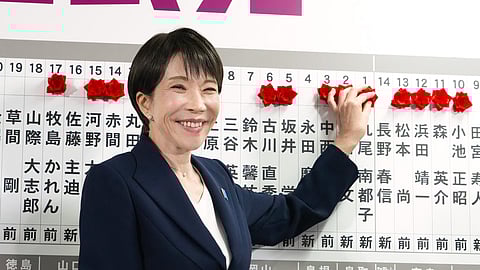 Sanae Takaichi, Japan's prime minister and president of the ruling Liberal Democratic Party (LDP), puts pins marking the names of candidates who won lower house elections at the LDP headquarters Sunday, Feb. 8, 2026 in Tokyo.