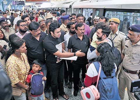 Bengaluru South MP Tejasvi Surya interacts with passengers at the RV Road Metro Station on Sunday.