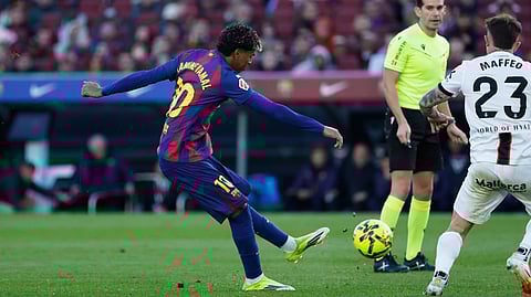 Barcelona's Lamine Yamal, left, scores his side's 2nd goal during the Spanish La Liga soccer match between Barcelona and Mallorca in Barcelona, Spain, Saturday, Feb. 7, 2026.