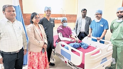 Patient with the surgical team post-replantation.