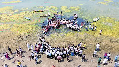 Fishing communities from 16 coastal villages staging a protest on the banks of the lagoon on Monday
