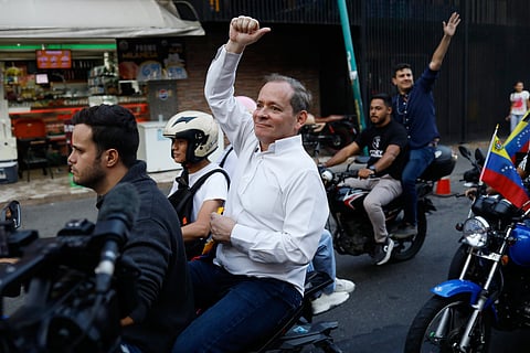 Opposition leader Juan Pablo Guanipa rides on the back of a motorcycle after his release from prison in Caracas, Venezuela, Sunday, Feb. 8, 2026.