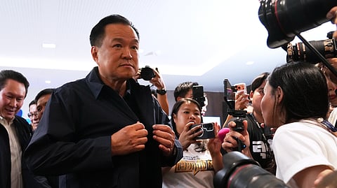 Thailand's Prime Minister and leader of Bhumjaithai Party Anutin Charnvirakul, center, leave after a press conference at the party headquarters following the general election in Bangkok, Sunday, Feb. 8, 2026.