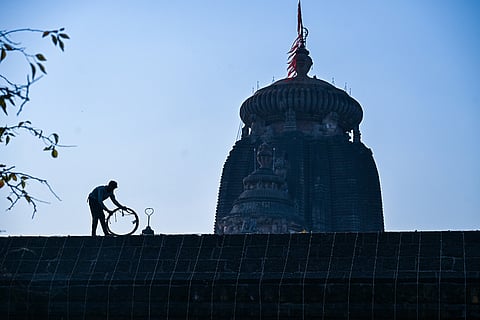 A man is laying out cables and wires to illuminate the 11th century Lingaraj Temple Complex ahead of Shivaratri in Bhubaneswar on Tuesday.