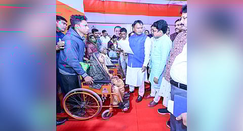 CM Mohan Charan Majhi interacting with an elderly woman at his grievance cell.