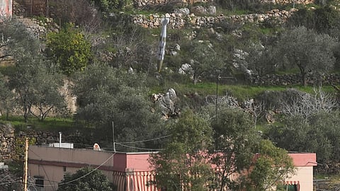 A bomb dropped from an Israeli jet falls before hitting a building in Ain Qana village, south Lebanon, Monday, Feb. 2, 2026.