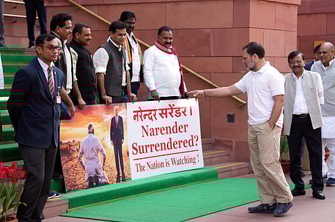 LoP in the Lok Sabha Rahul Gandhi, right, gestures as Lok Sabha MPs who were suspended last week for the remainder of the Budget session protest outside the Parliament.