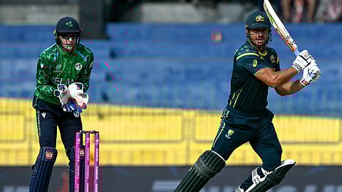 Australia's Marcus Stoinis (R) watches the ball after playing a shot during the 2026 ICC Men's T20 Cricket World Cup group stage match between Ireland and Australia.