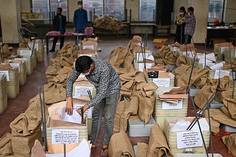 An official checks ballot boxes and voting papers before its distribution to various polling centers ahead of the national parliamentary election, in Dhaka, Bangladesh, Wednesday, Feb. 11, 2026.