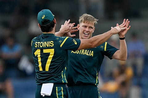 Australia's Nathan Ellis (R) celebrates with teammate Marcus Stoinis after taking the wicket of Ireland's Curtis Campher during the 2026 ICC Men's T20 Cricket World Cup.