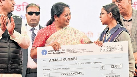 Delhi Chief Minister Rekha Gupta with a beneficiary of the scheme on Wednesday.