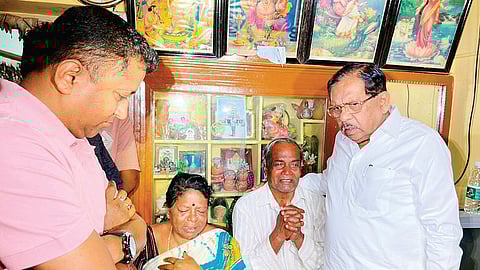 Home Minister G Parameshwara with the parents of Chandan Kumar, who was shot dead in Toronto, at their residence in Nelamangala on Tuesday.