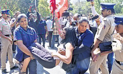 Police detain a protestor in front of Town Hall on Thursday