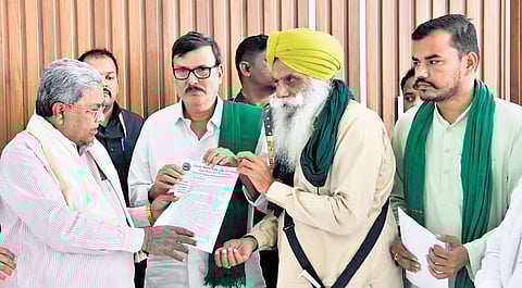 A delegation of farmers’ associations hands over a memorandum to
Chief Minister Siddaramaiah in Bengaluru on Thursday