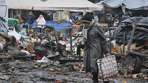 People walk at a ruined city market following a Russia's attack in Odesa, Ukraine, Thursday, Feb. 12, 2026