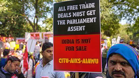 Members of trade unions hold banners during a nationwide strike to protest an interim trade deal with the United States, saying the agreement undermines the interests of farmers, small businesses and workers in New Delhi, India, Thursday, Feb. 12, 2026.