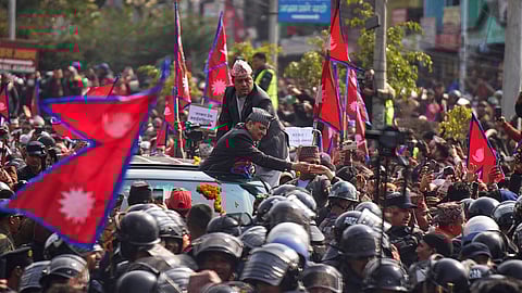 Former King Gyanendra Shah receives flowers from supporters upon his arrival at Tribhuvan International Airport in Kathmandu, Nepal, Friday, Feb. 13, 2026.