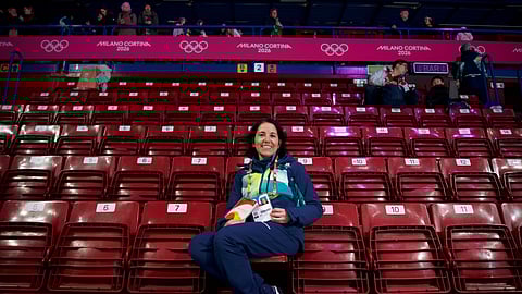 Cristina Romagnoli, a volunteer, poses at the venue that hosts the short track speedskating at the 2026 Winter Olympics in Milan, Italy, Sunday, Feb. 8, 2026.