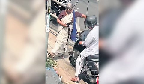 Prabhavathy blocking a motorist from using the footpath.