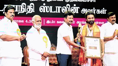 Deputy Chief Minister Udhayanidhi Stalin presenting state award to actor Dhanush at a function in Chennai on Friday.
