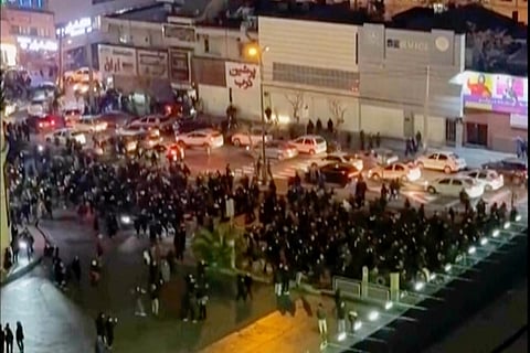 In this image from a video made by an individual not employed by The Associated Press and obtained by the AP outside Iran, people block an intersection during a protest in Tehran, Iran, on Jan. 8, 2026.