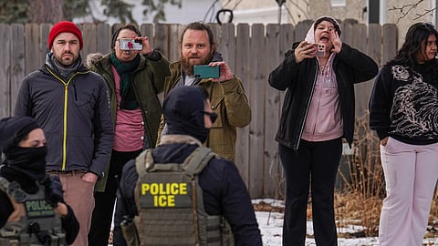 Observers film while federal agents conduct immigration enforcement operations on Thursday, Feb. 5, 2026, in Minneapolis.