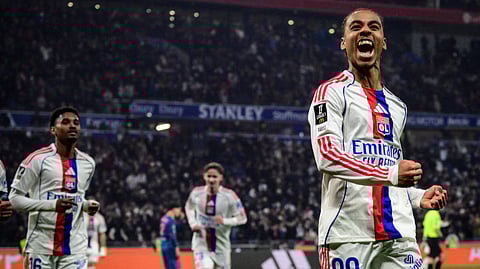 Lyon's Noah Nartey (R) celebrates after scoring Lyon's second goal during the French L1 football match between Olympique Lyonnais (OL) and OGC Nice at the Groupama Stadium in Decines-Charpieu, central-eastern France, on February 15, 2026.