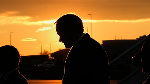 U.S. Secretary of State Marco Rubio, silhouetted against the setting sun, arrives at the Liszt Ferenc International Airport in Budapest, Hungary, Sunday, Feb. 15, 2026.