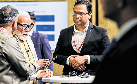 Prime Minister Narendra Modi at the Sarvam AI stall at the India AI Impact Expo in New Delhi, as Sarvam’s co-founder Pratyush Kumar looks on.