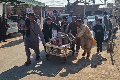 Volunteers transport an injured victim of a bomb explosion upon arrival at a hospital in Bannu, northwestern Pakistan, Monday, Feb. 16, 2026.