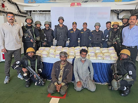 Apprehended Iranians Abdul Majeed and Abdul Sattar along with officers.