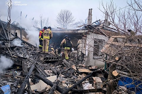 In this photo provided by the Ukrainian Emergency Service, firefighters put out the fire in private houses following a Russian air attack in Sumy region, Ukraine, Tuesday, Feb 17, 2026.