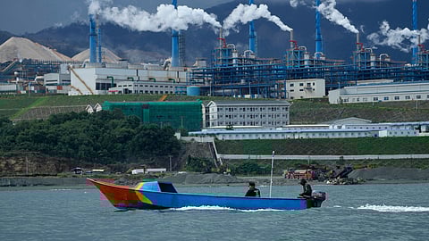 A boat cruises past a nickel processing plant at Indonesia Weda Bay Industrial Park in Central Halmahera, North Maluku province, Indonesia, June 8, 2024.