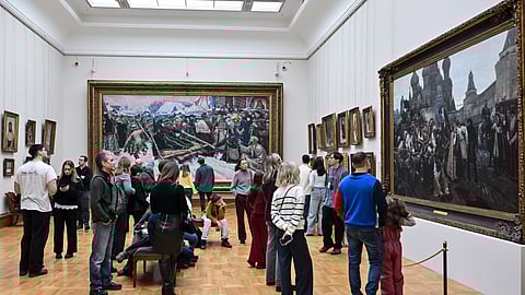 People look at paintings of Russian painter Vasily Surikov as they visit the Tretyakov gallery in central Moscow on February 15, 2026.