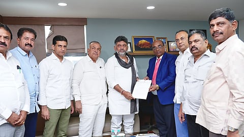 A delegation led by Deputy Chief Minister D K Shivakumar submits a memorandum to State Election Commissioner G S Sangreshi in Bengaluru