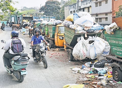 Garbage collection autos and trucks line up in the city on Wednesday