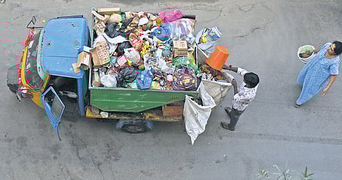 A garbage collection auto tipper makes the rounds of a residential area after Bellahalli villagers call off the stir.