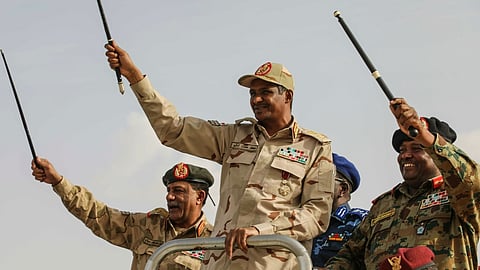 Gen. Mohammed Hamdan Dagalo, center, greets the crowd during a military-backed tribes' rally in the Nile River State of Sudan, July 13, 2019.