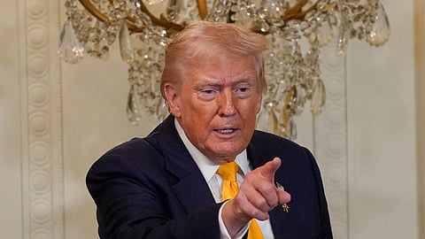 US President Donald Trump gestures during a Black History Month event in the East Room of the White House, Wednesday, Feb. 18, 2026, in Washington