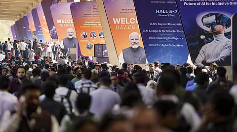 Scores of people line up at the exhibition halls' entry gates to attend the AI Summit at Bharat Mandapam, New Delhi