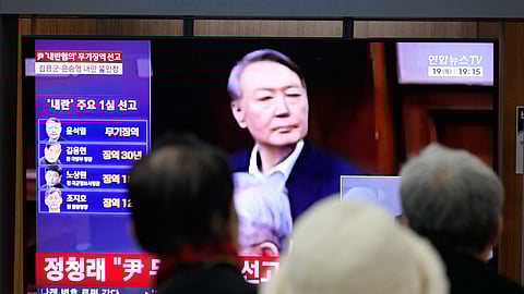 A TV screen shows an image of former South Korea President Yoon Suk Yeol during a news program at the Seoul Railway Station in Seoul, South Korea, Thursday, Feb. 19, 2026.