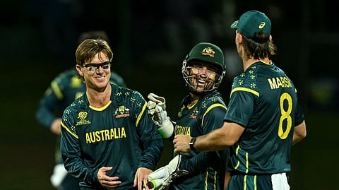 Australia's Adam Zampa (L) celebrates with teammates after taking the wicket of Oman's Shakeel Ahmed during the 2026 ICC Men's T20 Cricket World Cup group stage match between Oman and Australia at Pallekele International Cricket Stadium in Kandy.