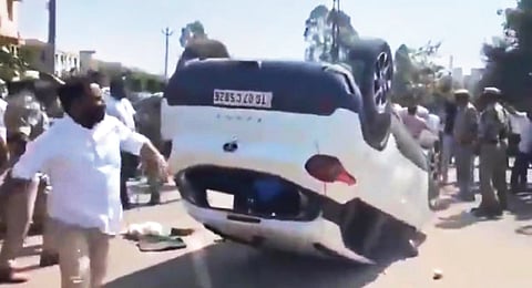 Alleged supporters of Kamareddy BJP MLA Venkata Ramana Reddy overturn the car of a Congress leader during the clash on Saturday