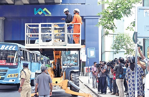 Fire and Rescue Services personnel and animal rescue team attempting to rescue a cat stranded atop a metro pillar for days