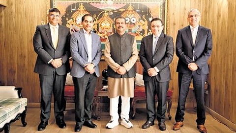 Union minister Dharmendra Pradhan with VFS Global CEO Zubin Karkaria (to his left) and his team members in New Delhi, on Saturday